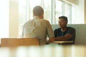 two men actively participating in a productive conversation about call out culture 